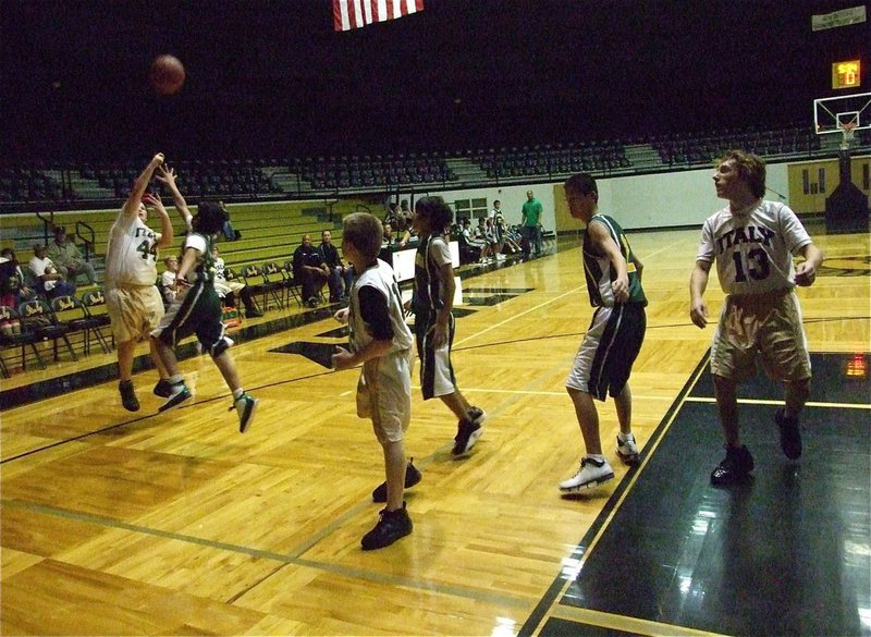 Image: Byers from beyond — Italy’s John Byers(44) knocks down a 3-pointer over an INH defender.