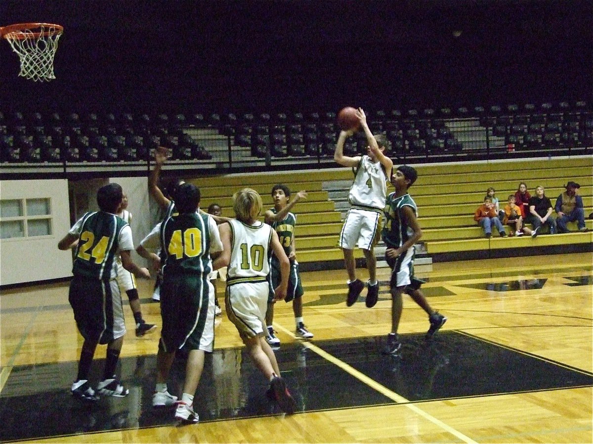 Image: Justin pulls up — Justin Wood(4) pulls up for jump shot against Irving North Hills.