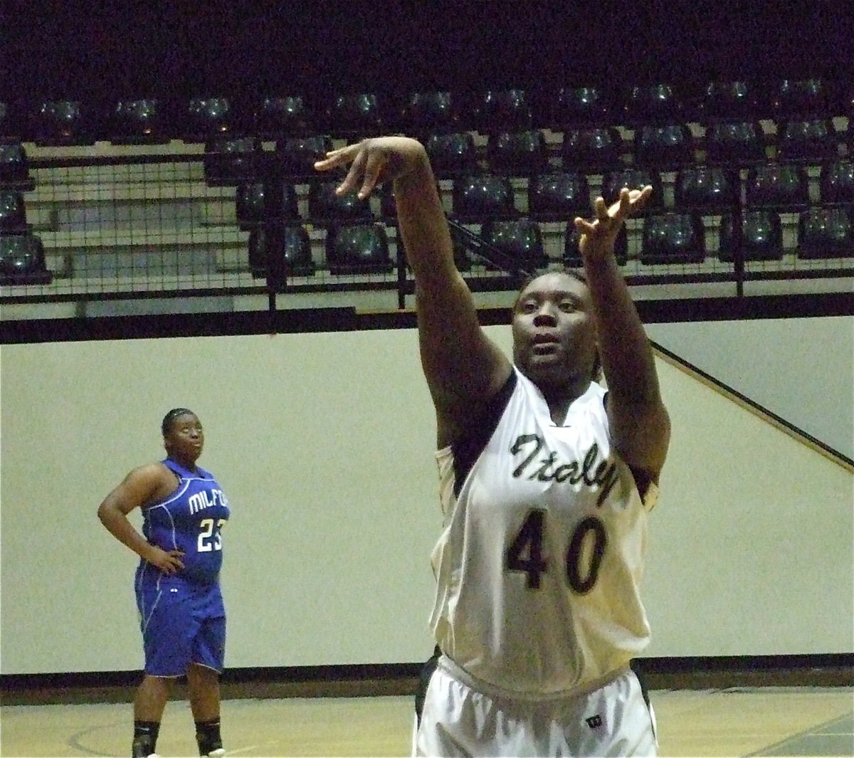 Image: Reed from the line — Jimesha Reed has Milford looking for answers as she concentrates on her form to put in a free throw against the Bulldogs.