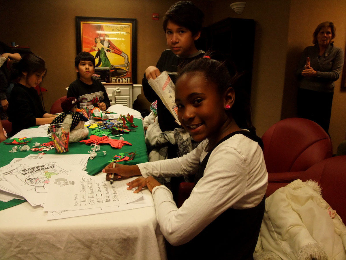 Image: Busy Writing Santa — She was writing Santa with a long list of wishes for Christmas.