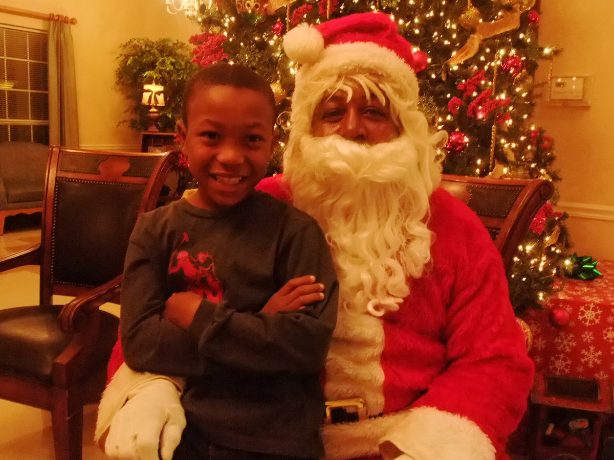 Image: Santa is Very Busy — Santa was very busy having his picture taken with friends and family.