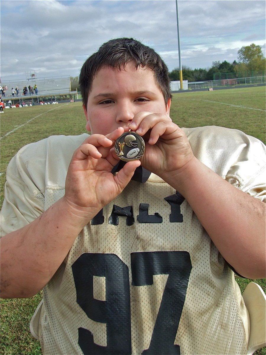 Image: Mateo’s a Champion — Mateo Jacinto(97) holds his Superbowl Championship medal up with pride.