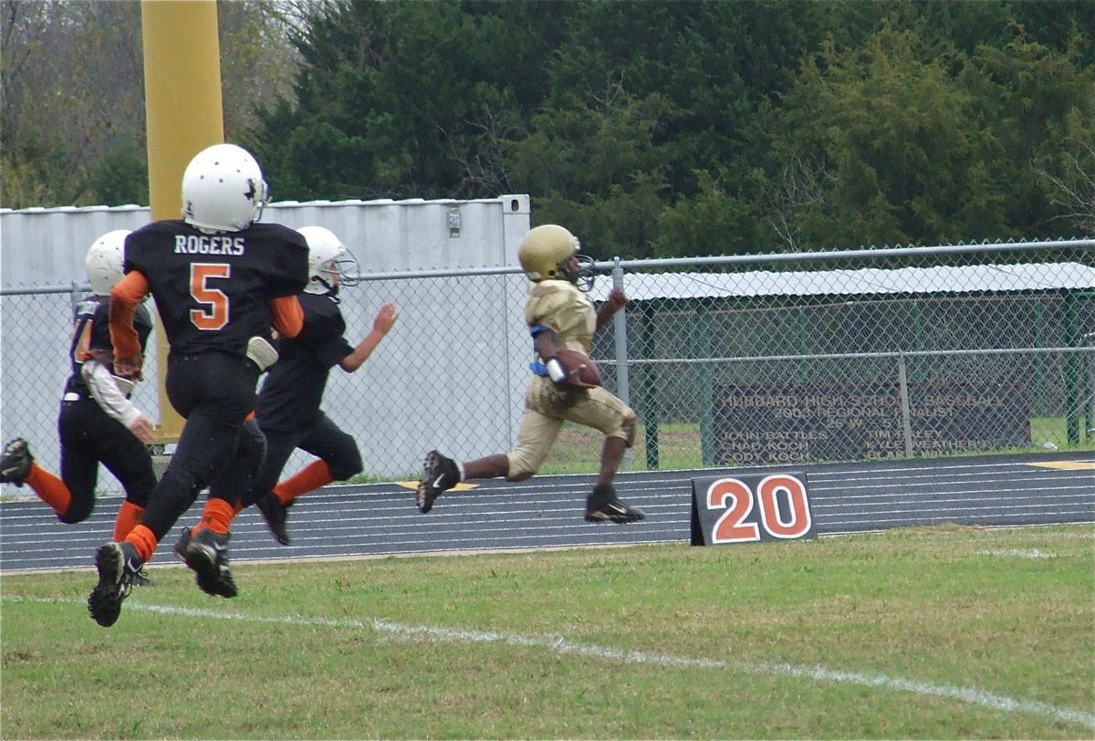 Image: Taron glides downfield — Third Grader, Taron Smith(21), blasts off against Ferris.