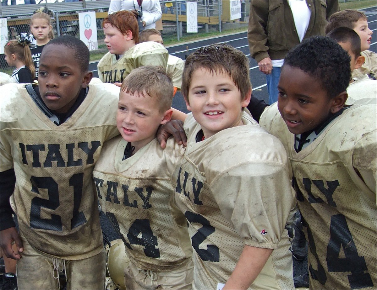 Image: We did it! — Christian Cole(21), Bryce DeBorde(44), Holden Schrotke(22) and Jaiden Barr(34) are muddy but better for it after knocking out the Ferris Yellowjackets 18-0 to complete an undefeated, unscored on season to finish 8-0. “Knockout” was also the name of their defensive formation.