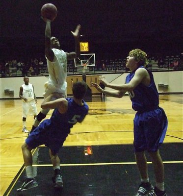 Image: Heath goes for it — Clemons takes one for the team as he attacks the basket.