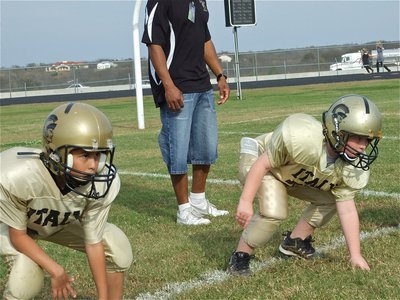 Image: Michael and Levi — 2nd Graders Michael Gonzalez(30) and Levi Stark(79) practice firing off the ball before their Conference Championship matchup against Hubbard.