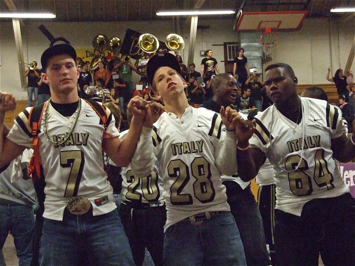 Image: We love you so… — Kyle Wilkins(7), Kyle Jackson(28) and Bobby Wilson(64) unite for the school song.