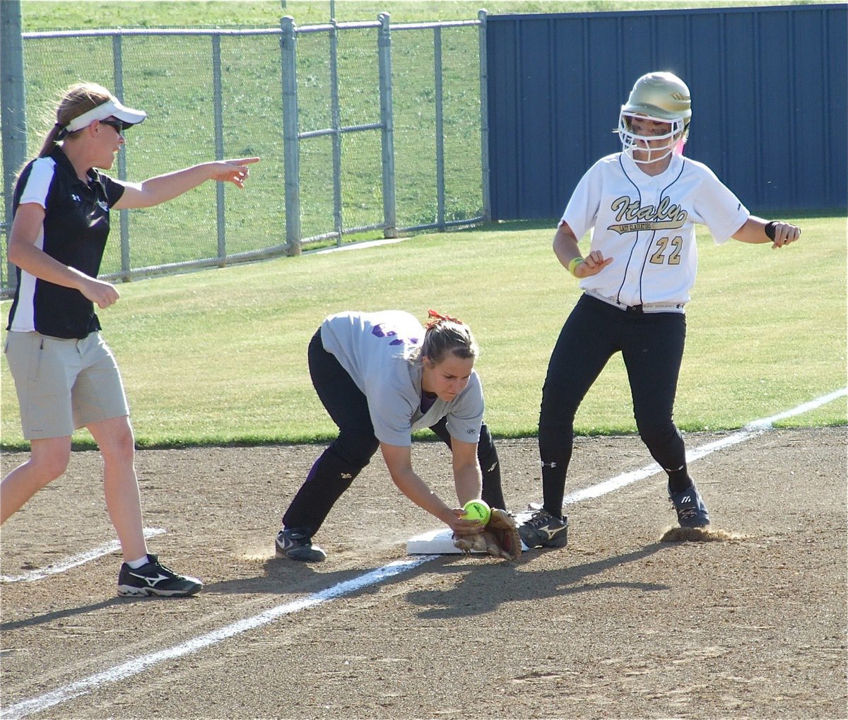 Image: Megan triples — Stay! Italy head coach Jennifer Reeves directs Megan Richards to stay on the third base bag after Richards tripled to score 1 run against Tolar Friday in the top of the 1st inning.