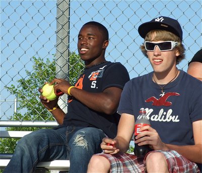 Image: Foul ball — Italy Gladiator Jasenio Anderson sits with teammate Colton Campbell as Anderson collects a foul ball while watching the Lady Gladiators take on Tolar at Fort Worth Brewer High School.