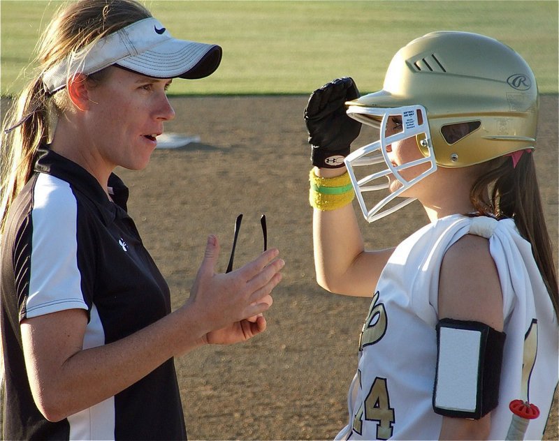 Image: Top secret — Italy head coach Jennifer Reeves explains the strategy to Drew Windham before Windham goes up to the plate.