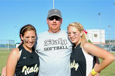 Image: Allen’s proud — Allen Richards holds his oldest two daughters, Alyssa and Megan, after their dramatic come from behind effort to win 9-8 over Tolar. Allen’s youngest daughter, Brycelen (not pictured), is growing up Lady Gladiator as well.