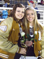 Image: Two roses — Senior cheerleaders Cori Jeffords and Lexie Miller manage smiles knowing their about to cheer their last cheers at Willis Field.