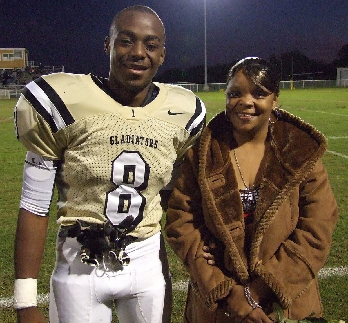 Image: Desmond and his mom — Desmond hands his mom a rose on Senior Night.