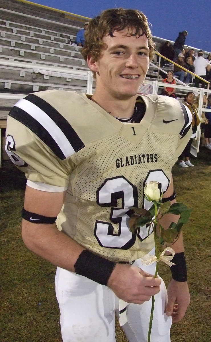 Image: Justin “Huck” Hayes — Senior Justin Hayes is proud to give his mom a rose on Senior night.