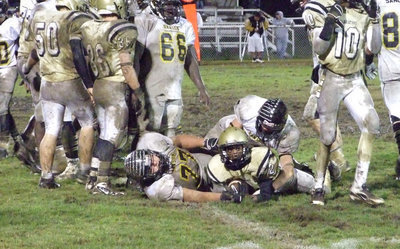 Image: Heath peaks — Heath Clemons peaks up from the pile to see if he got the first down.