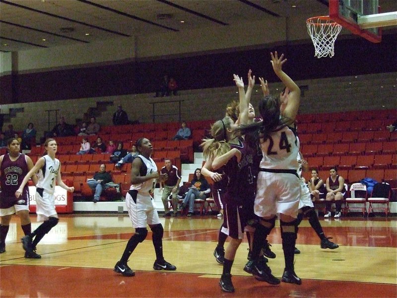 Image: Alyssa under pressure — Alyssa Richards(24) gets up a shot despite Lady Eagles pecking at her heels.