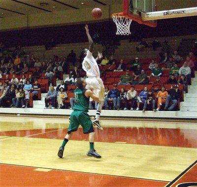 Image: John finishes — John Isaac(10) gives Kerens a dose of their own medicine as he finishes the fast break.