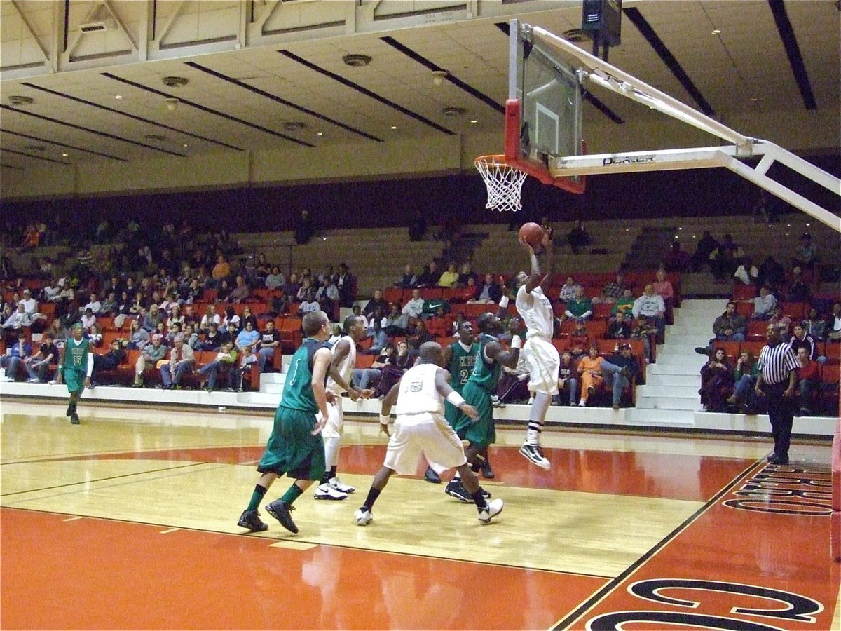 Image: Isaac on the boards — John Isaac(10) banks the ball into the basket.