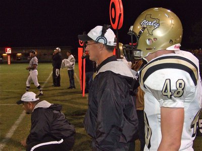 Image: Calling the plays — Coaches Craig Bales and Kyle Holley helped guide the Gladiators from the sideline as Ryan Ashcraft(48) gets ready to go in.
