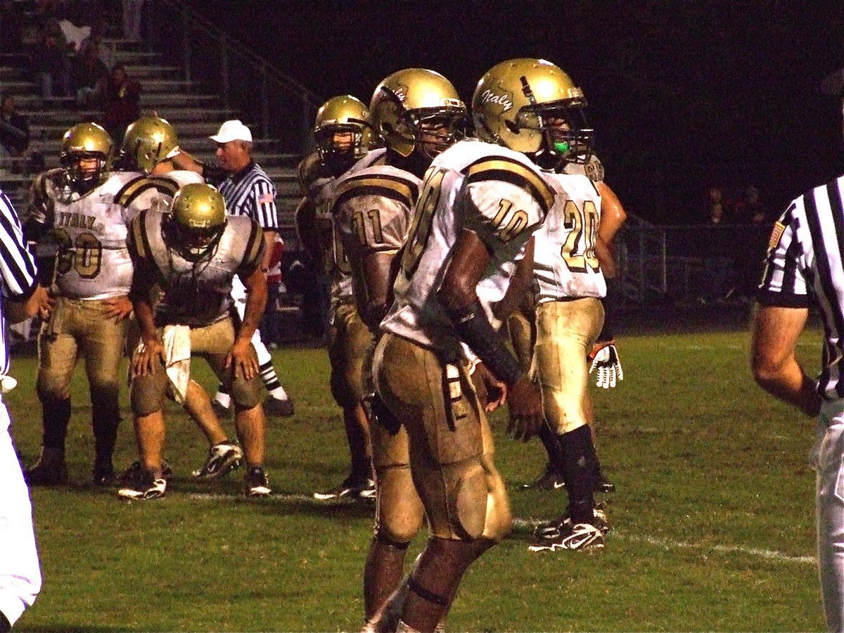 Image: Getting the play — Jasenio and John get the play call from Coach Craig Bales.