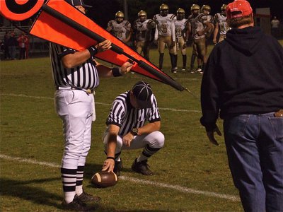 Image: Checking the chains — Italy’s offense is interested to see if they got a first down against the Axtell defense.