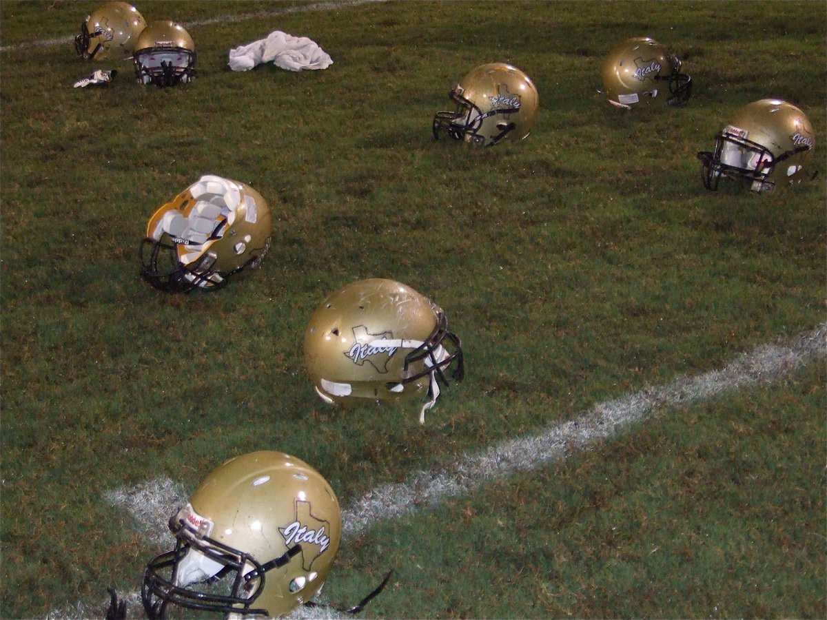 Image: Hats off to the horns — After removing their helmets, the Gladiators acknowledged the Axtell school song in a display of respect.