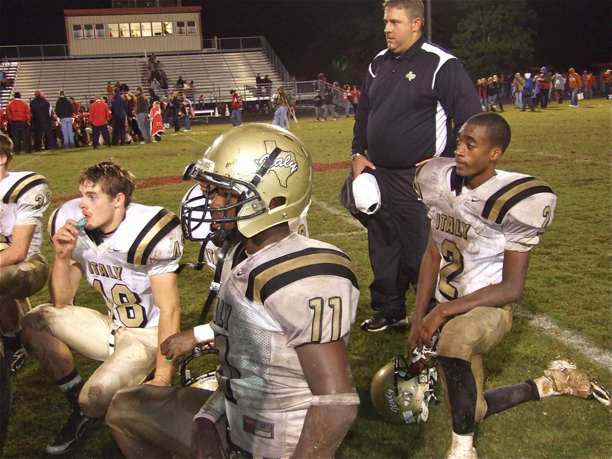 Image: A win is a win — Coach Matt Coker and the members of the Gladiator football team during the post-game huddle.