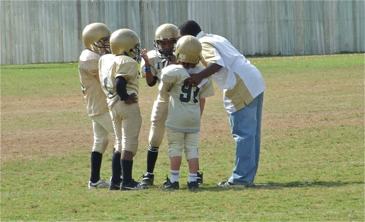 Image: Up the middle — Coach Wallace gives the play to his backfield.