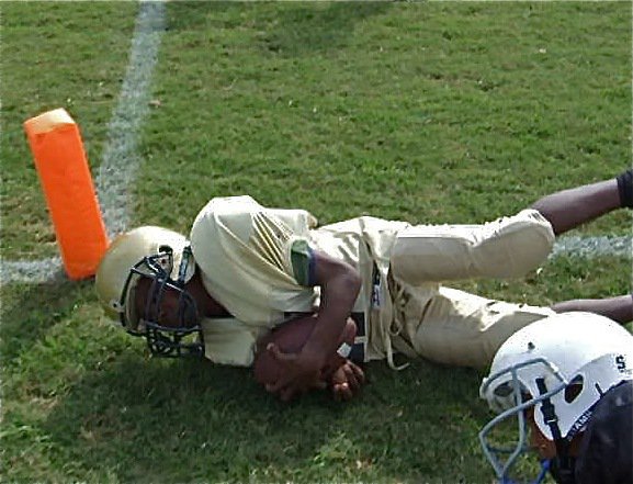 Image: So close! — Taron Smith gets taken out at the 1-yard line setting up a special moment for one of his teammates.