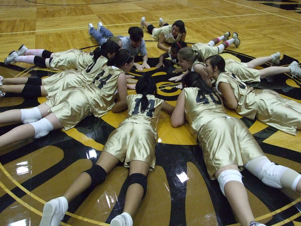 Image: Winner’s Circle — Coach Windham and the 8th grade volleyball team circle up after the win against the Lady Owls Monday night.