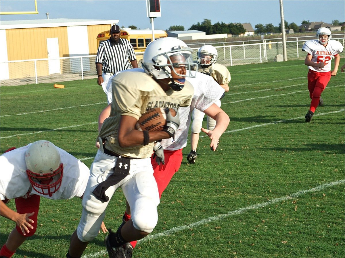 Image: Trevon scrambles — The Axtell Longhorns just couldn’t rope in Trevon Robertson and the Junior High offense.