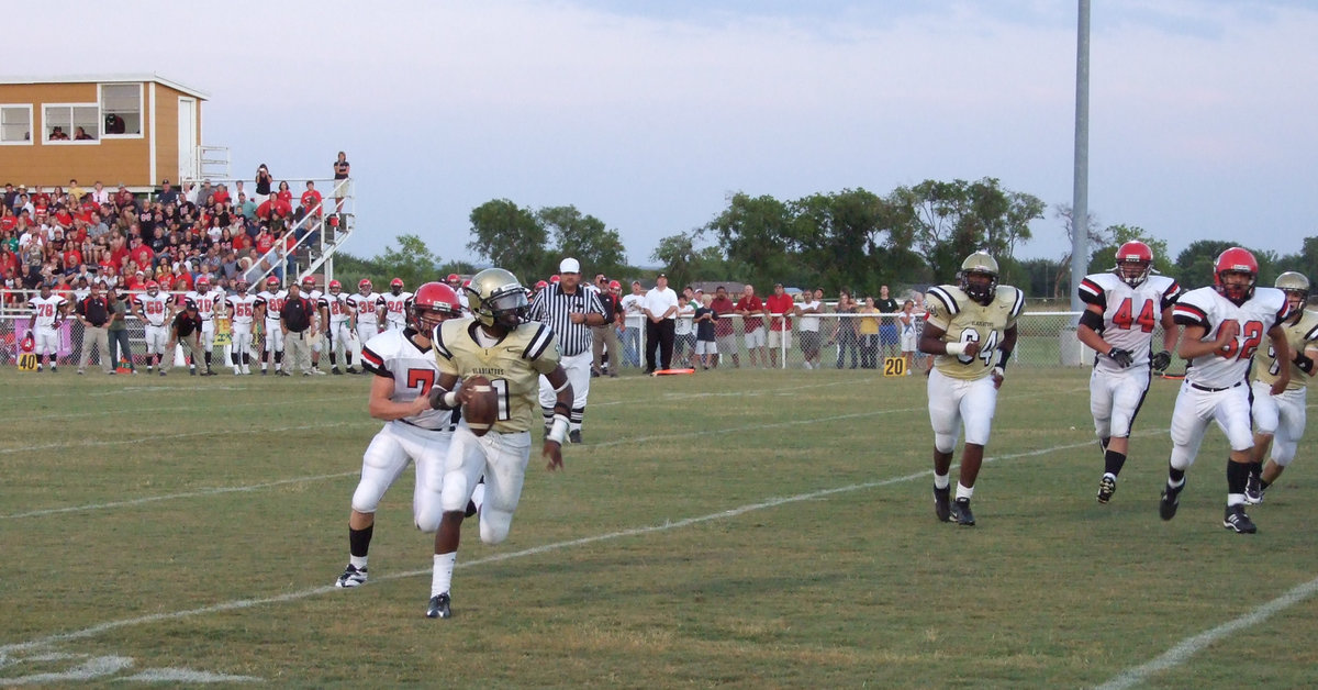 Image: Jasenio rolls right — Italy Quarterback, Jasenio Anderson, kept the Gladiators in the game until the very end.