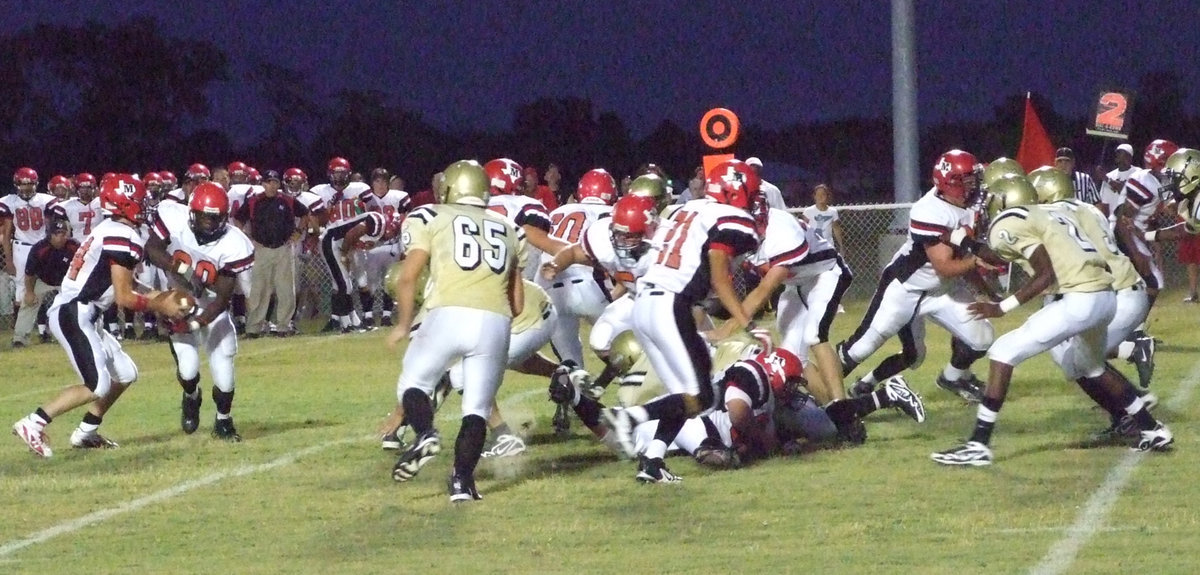 Image: Team defense — Jonathan Nash #65 and Heath Clemons #2 react to the Maypearl backfield.