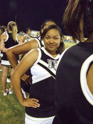 Image: Destani smiles — Cheerleader, Destani Anderson, has a moment for the camera.