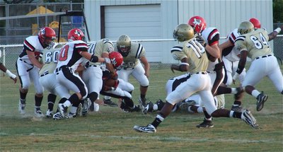 Image: Ethan excells — Linebacker Ethan Simon stuffs the panther running back at the line of scrimmage.