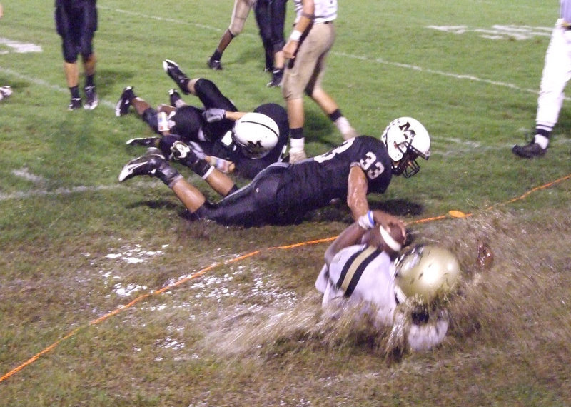 Image: A little water and a some mud made football fun Friday night — Italy quarterback Jasenio Anderson gets knocked out-of-bounds as he slides through the soggy sideline at Malakoff stadium.