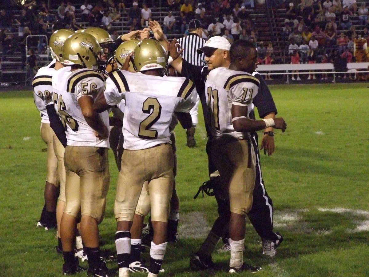 Image: Huddle up — Coach Craig Bales gets his players pumped up.