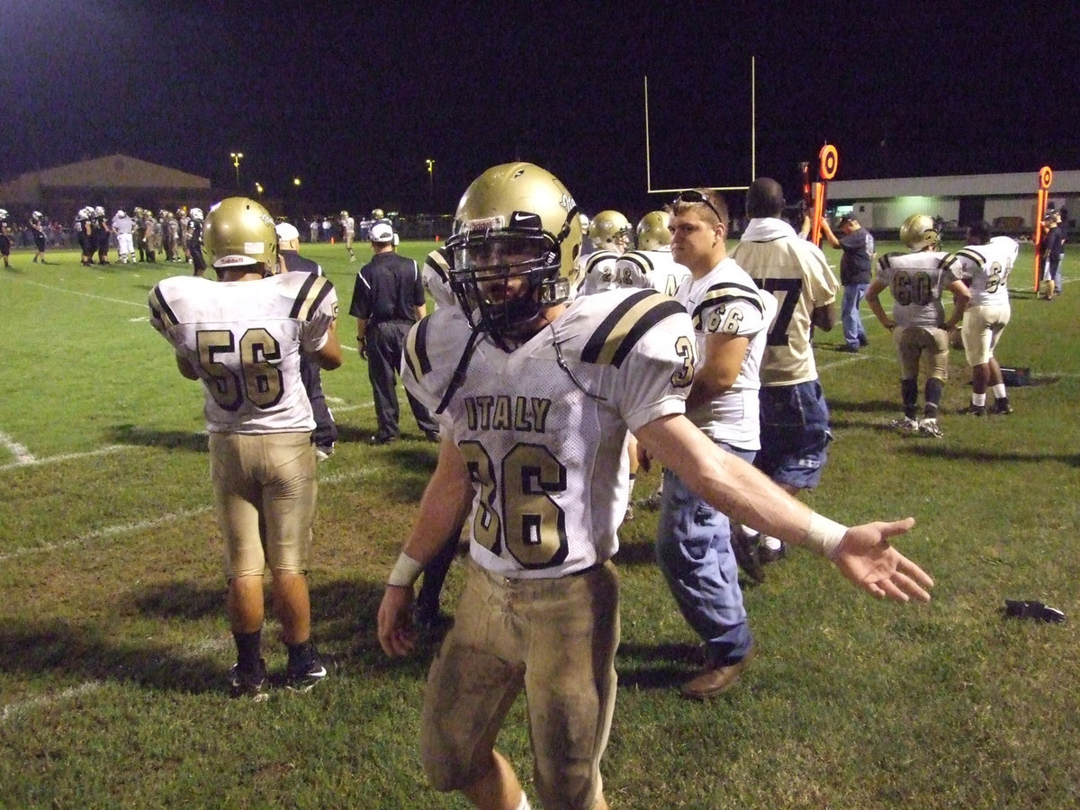 Image: Gimme five! — Justin Hayes(36) tries to keep the spirit up on the sideline.