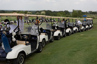 Image: Tee Time — Golfers line up to tee off for the Meals-on-Wheels Golf Benefit.