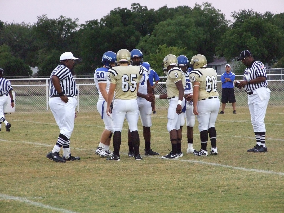 Image: Good sports — Captains of each team take the field before the game for a handshake and rules.