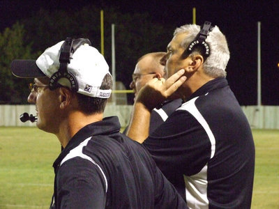 Image: Concerned coaches — Coach Holley, Coleman and Sollers carefully instruct the Gladiators.
