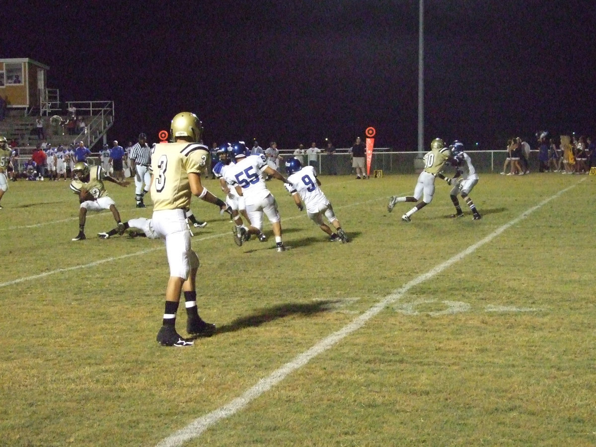 Image: Heath searches — Heath Clemons tries to find a running lane through a wave of Pirates.