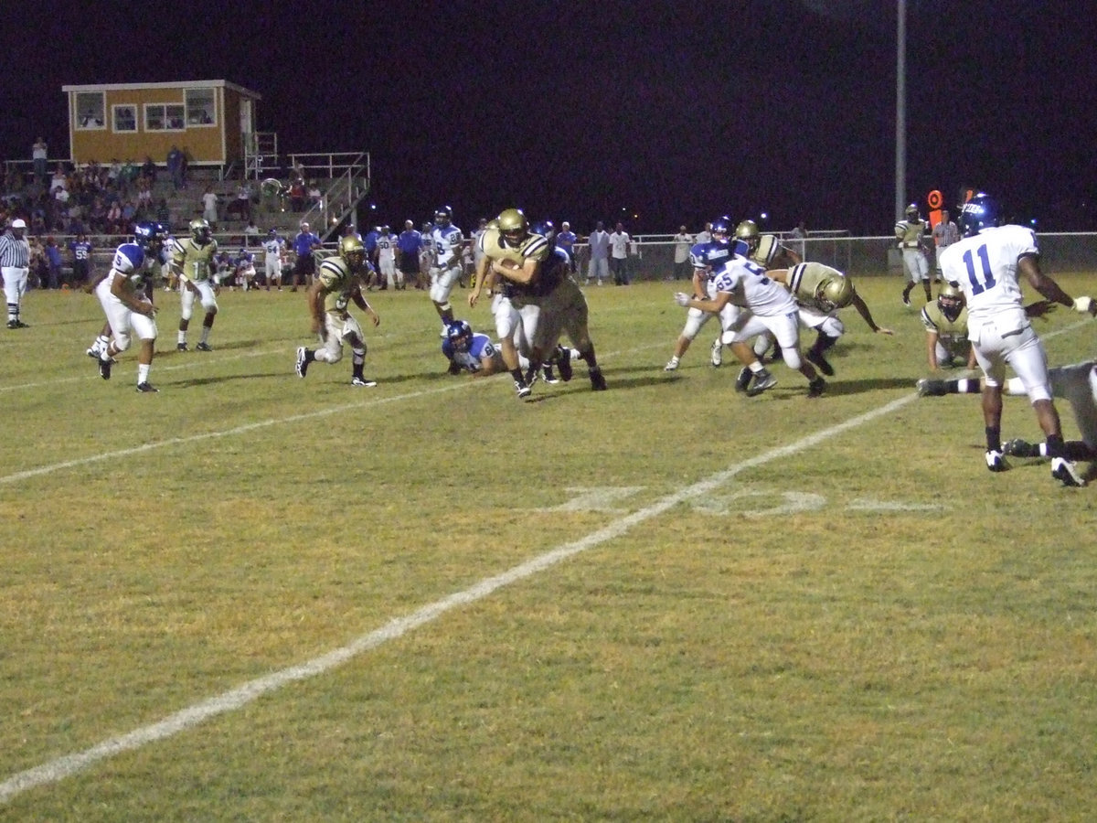 Image: Wilkins runs — Junior Kyle Wilkins guards the ball from the thieving Pirates.