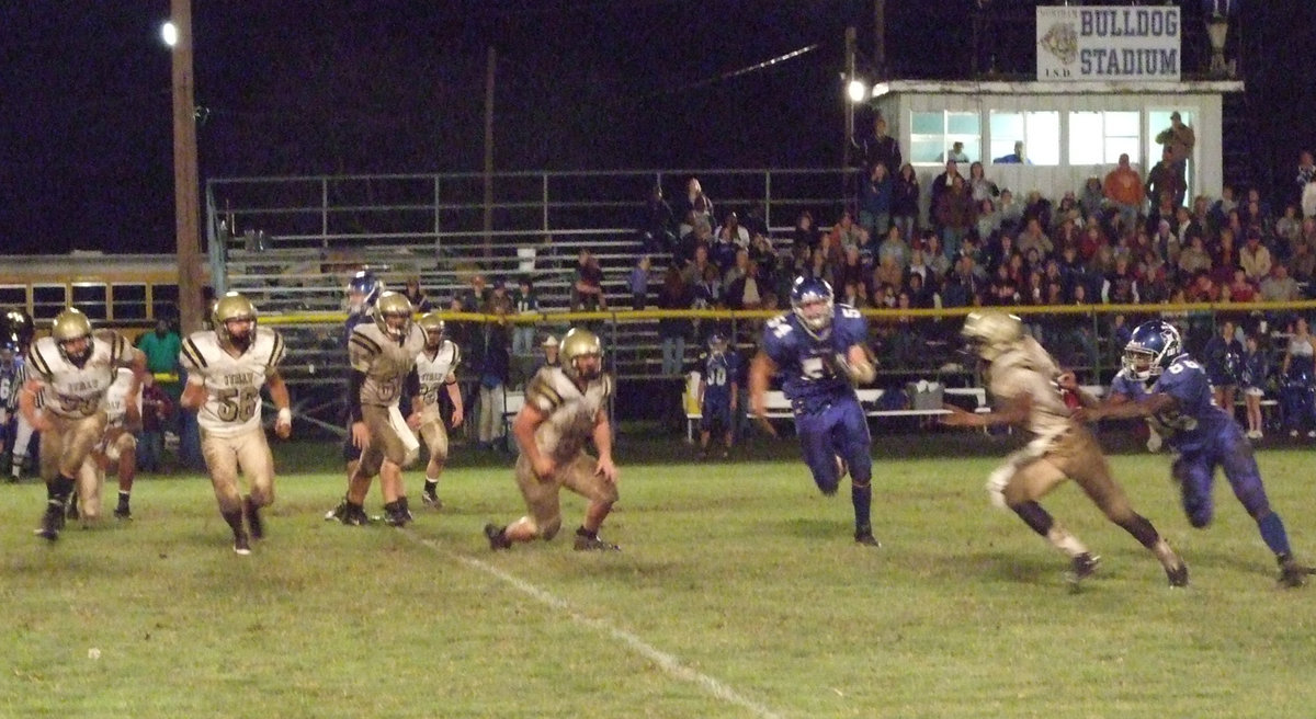 Image: You can’t stop him — Italy quarterback Jasenio Anderson has a Bulldog nipping at his heels.