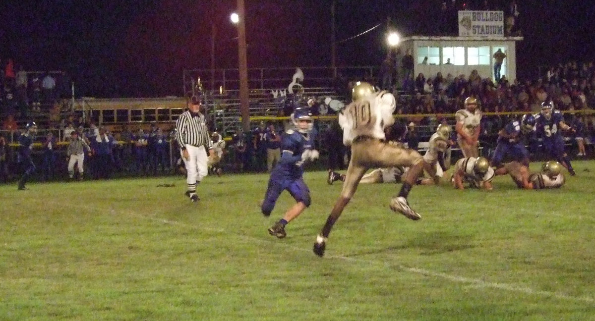 Image: Behind enemy lines — John Isaac(10) hauls in a pass before beaking tackles for extra yards.