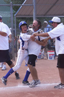 Image: Emotional victory — Coaches battle for hug with World Series hero Lane Bogy who just nailed the tournament winning home run!