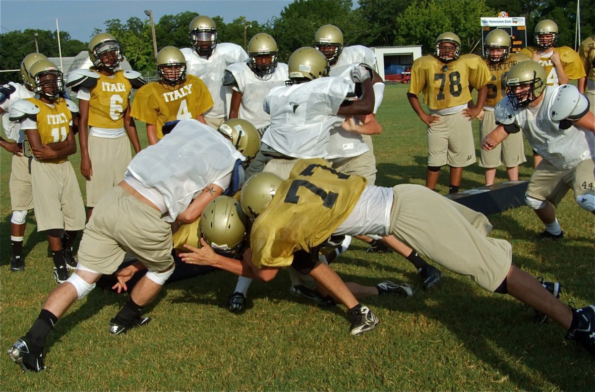 Image: Chaos and carnage: The Gladiators go full armor — Gladiator Kyle Wilkins tries to bust thru the line during a 3-on-3 drill.