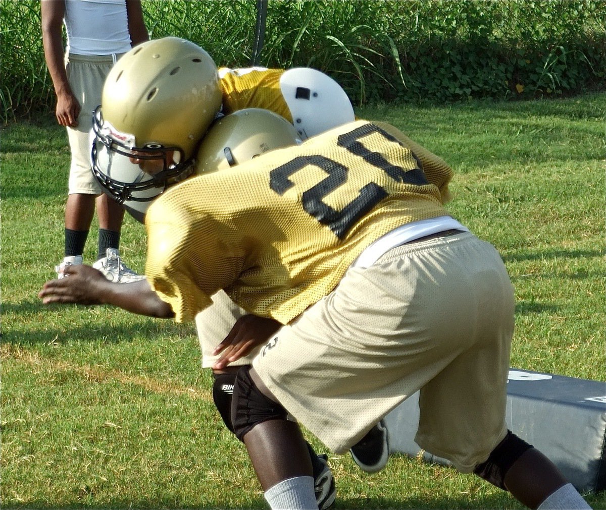 Image: Earhole — #20 earholes a teammate during a 3-on-3 full contact drill.