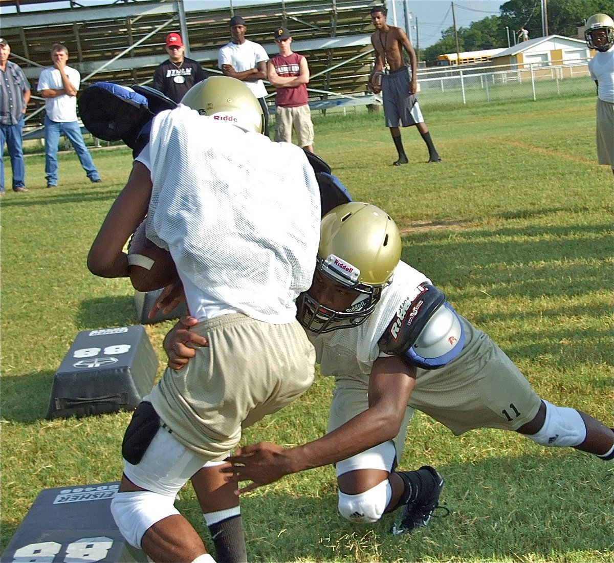 Image: Nice tackle — Jasenio Anderson takes a teammate down outside the boundaries.