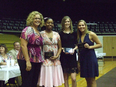 Image: Varsity Basketball — (L-R)Coach Stacy McDonald, Jaleecia Fleming, Kaitlyn Rossa and Becca DeMoss.